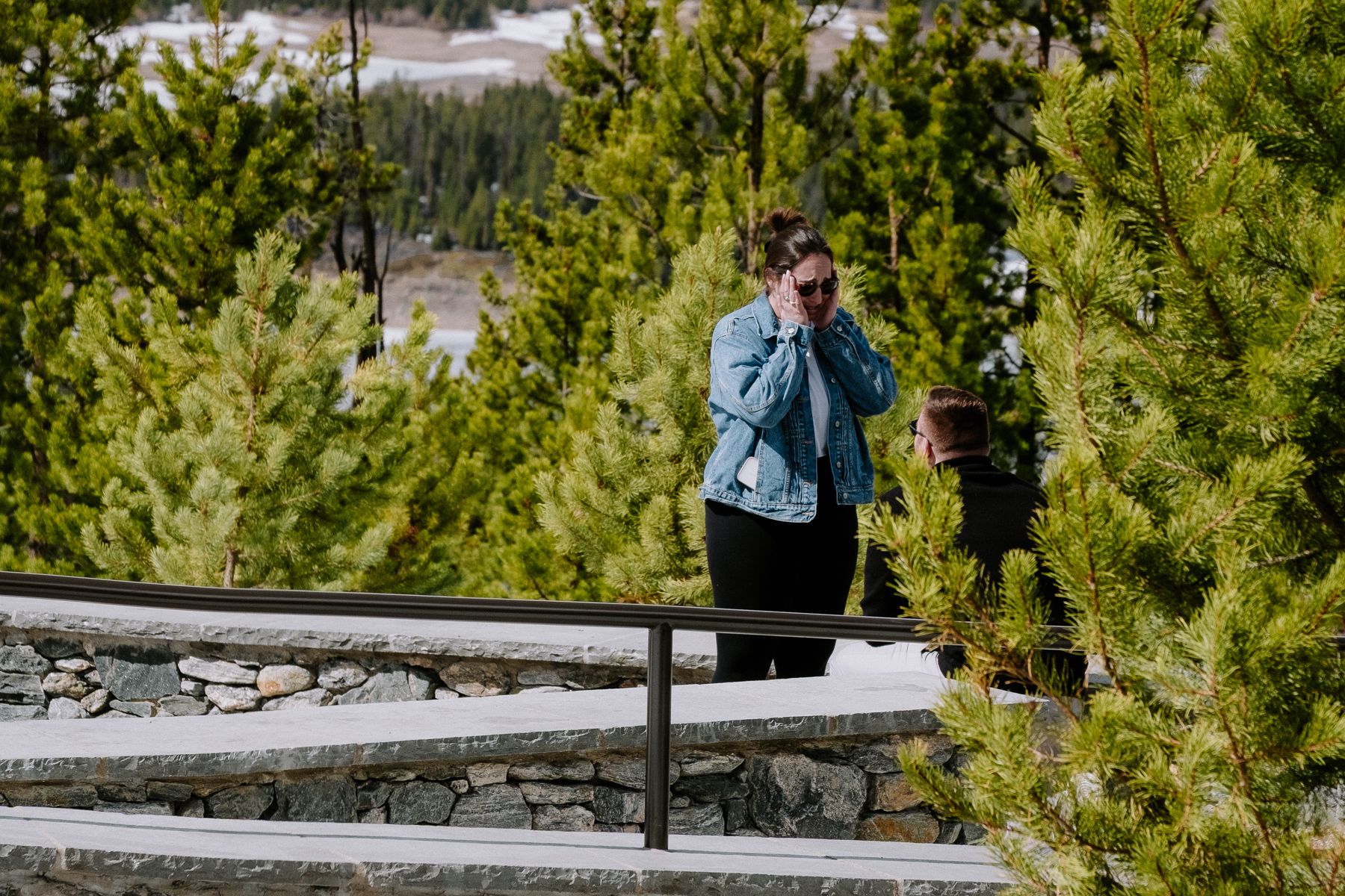 Surprise engagement reaction at mountain overlook